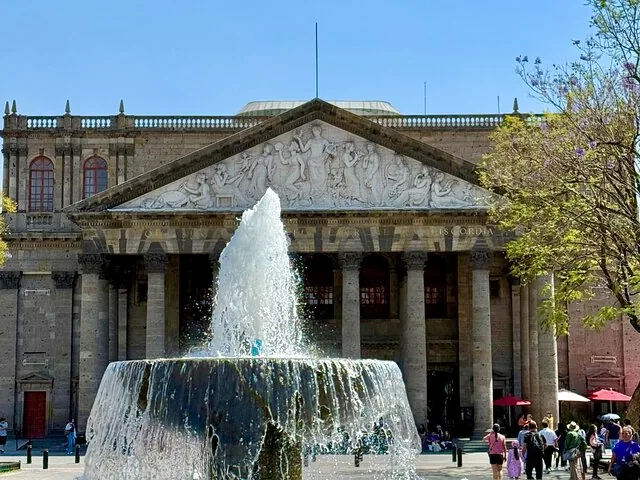 Fountain spraying water in front of Teatro Degollado facade